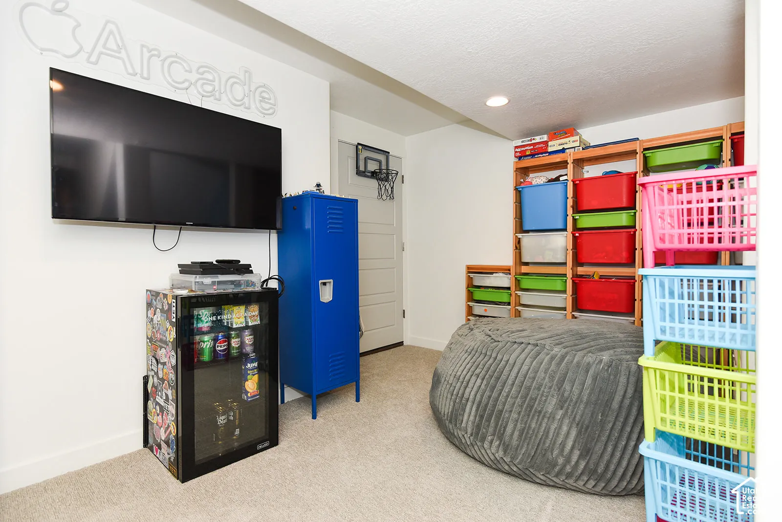 Wall-mounted television with white wall finish and recessed lighting