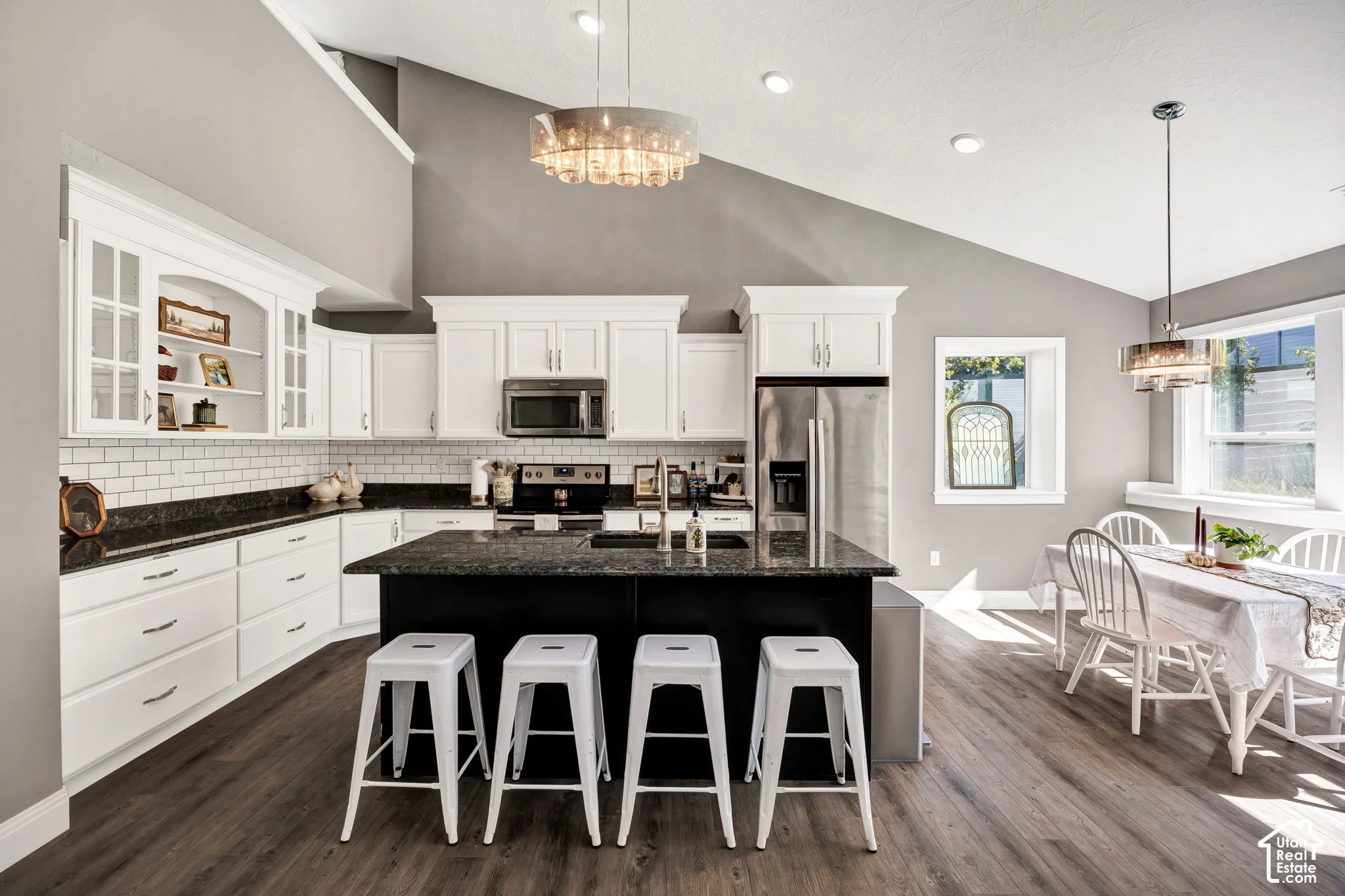 Kitchen featuring white cabinetry, dark countertops, and stainless steel appliances