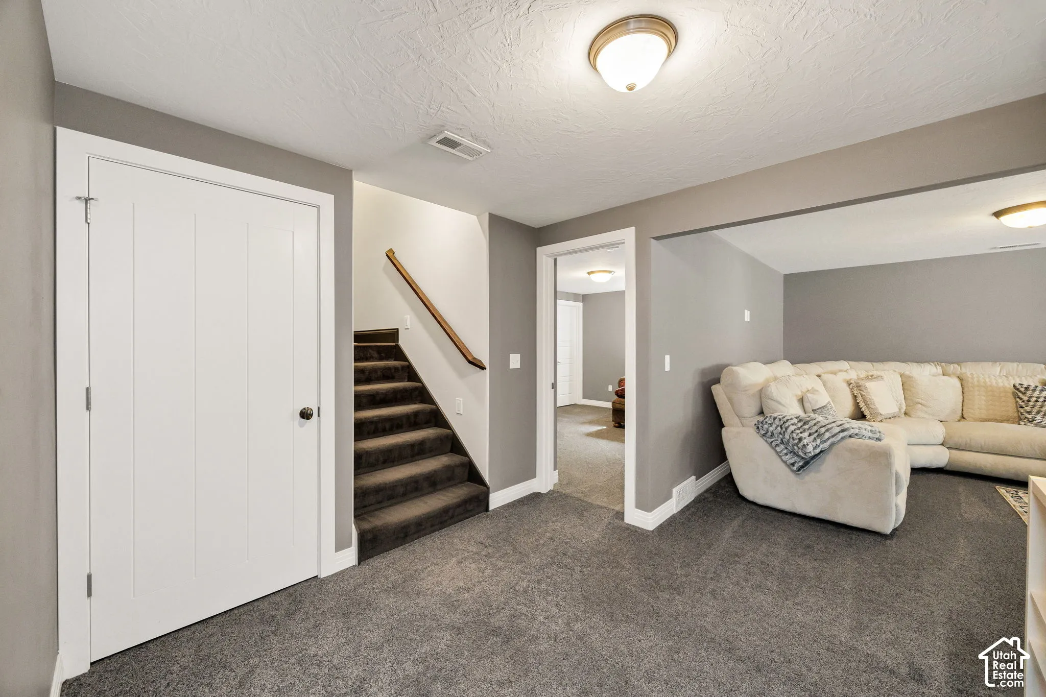 Wall-to-wall carpeting, recessed ceiling lighting, and a neutral color palette