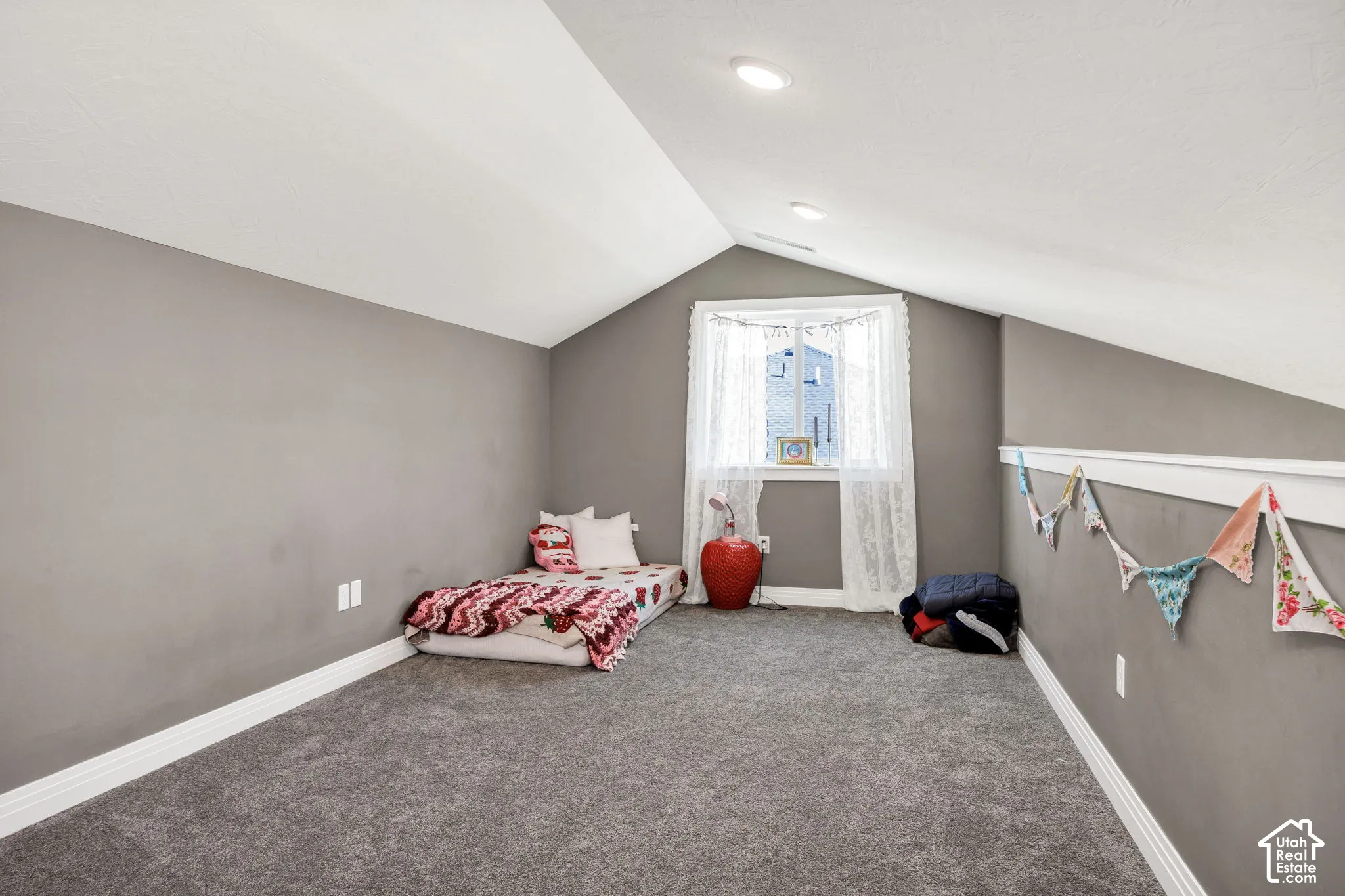 Gray wall paint, white trim, recessed lighting, white window frame, and gray carpeting