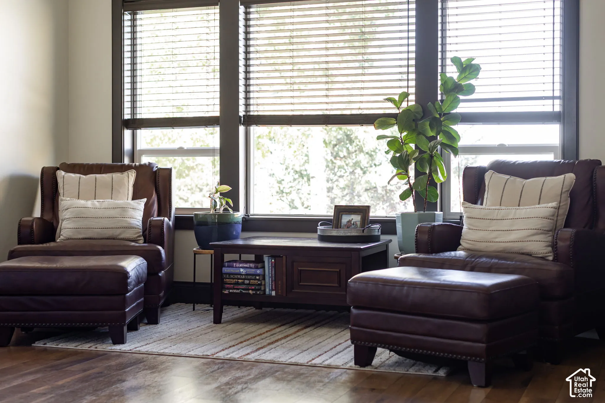 Wood-finish flooring with a multi-pane window featuring blinds