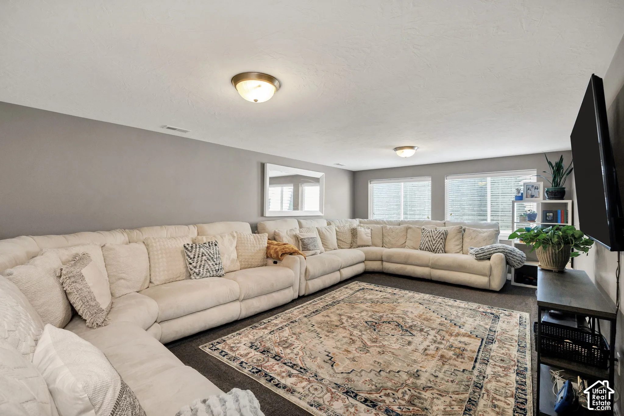 Recessed ceiling lighting, multiple windows, and neutral wall tones