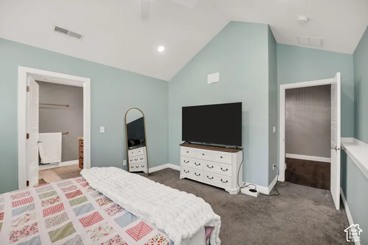 Vaulted ceiling, recessed lighting, and soft blue walls
