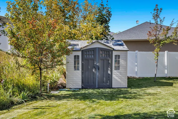 Exterior storage shed with double doors and side windows