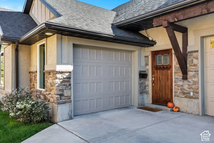 Stone veneer and stucco exterior with a durable shingle roof