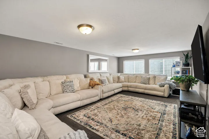 Recessed ceiling lighting, multiple windows, and neutral wall tones