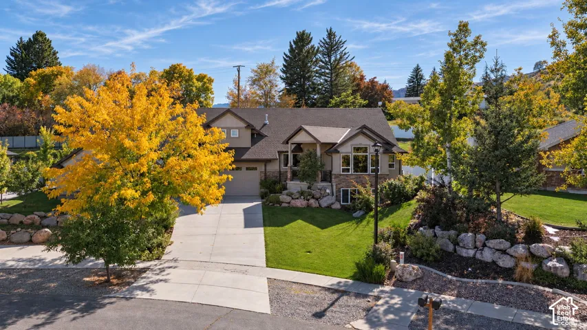 Two-story residence with a two-car garage, stone and stucco exterior, and a gabled roof