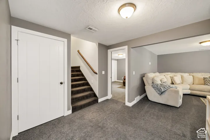 Wall-to-wall carpeting, recessed ceiling lighting, and a neutral color palette