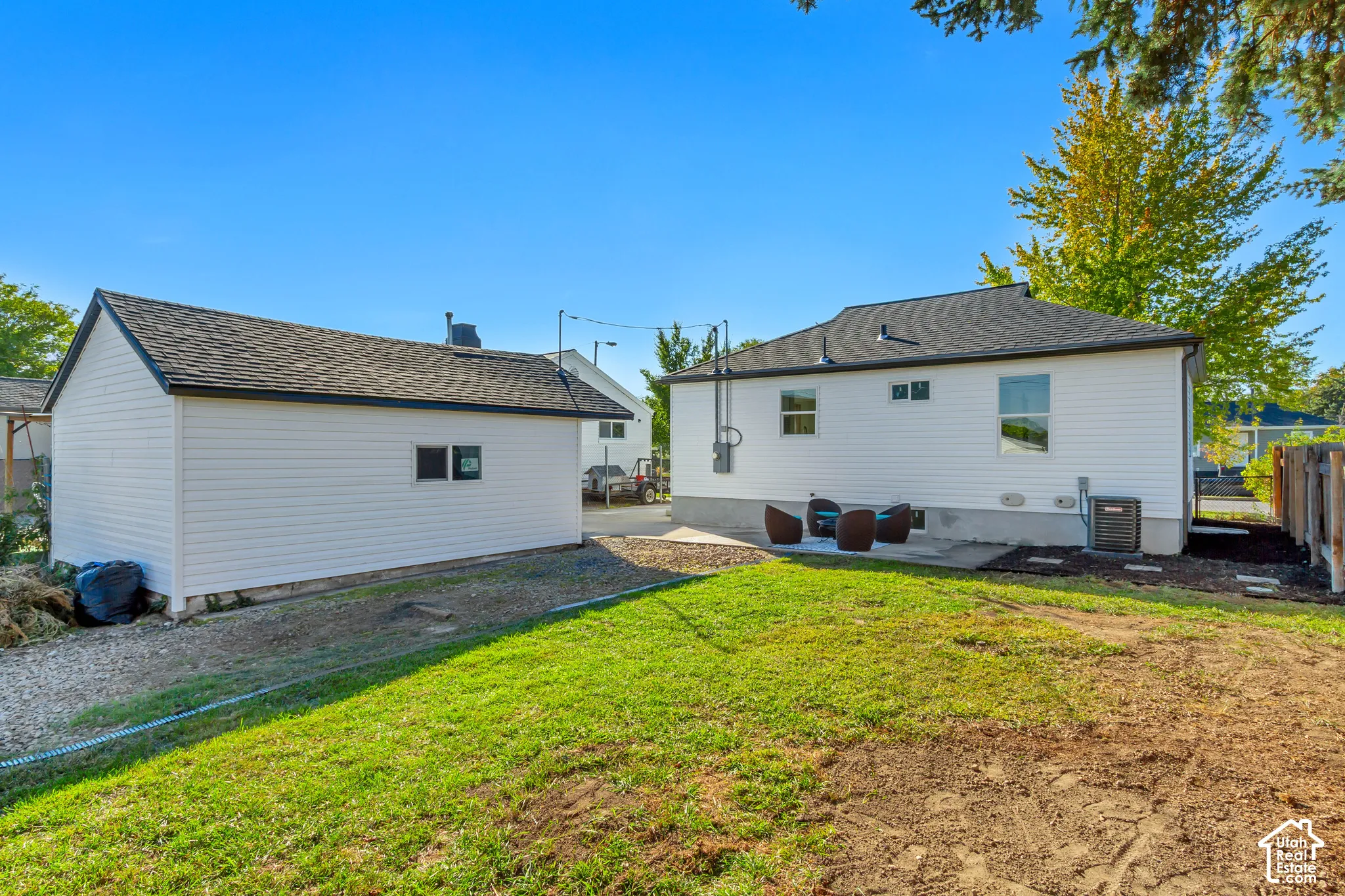 Detached structure with siding exterior and dark shingle roofing