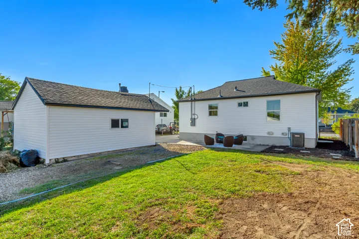 Detached structure with siding exterior and dark shingle roofing