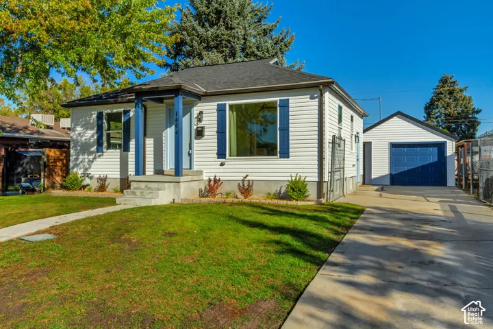 White siding exterior with a dark roof and blue accents