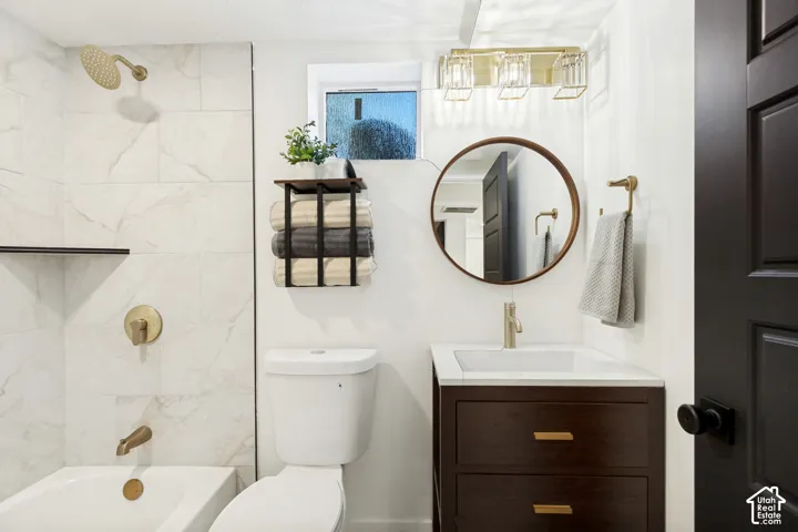 White subway tile shower surround with gold-finish fixtures