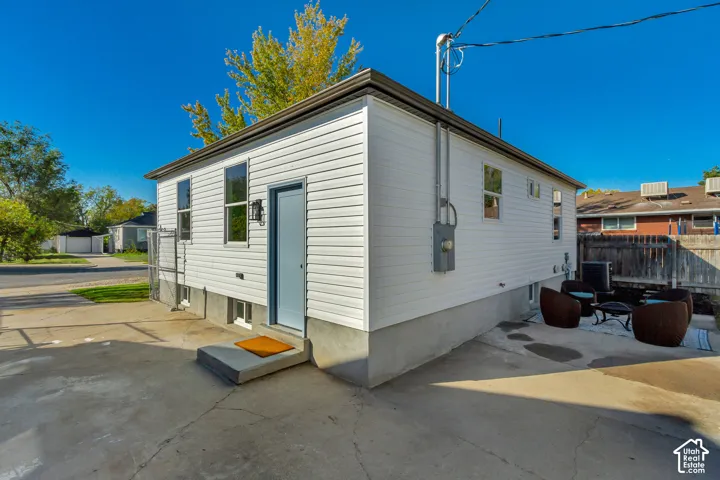 White horizontal siding exterior with a light blue entry door