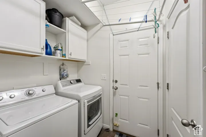 White shaker-style cabinetry with chrome hardware, an overhead shelf, a paneled door, and wood-finish flooring