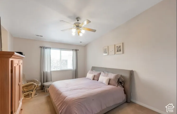 Recessed window with natural light, ceiling fan with integrated lighting, wall-to-wall carpeting