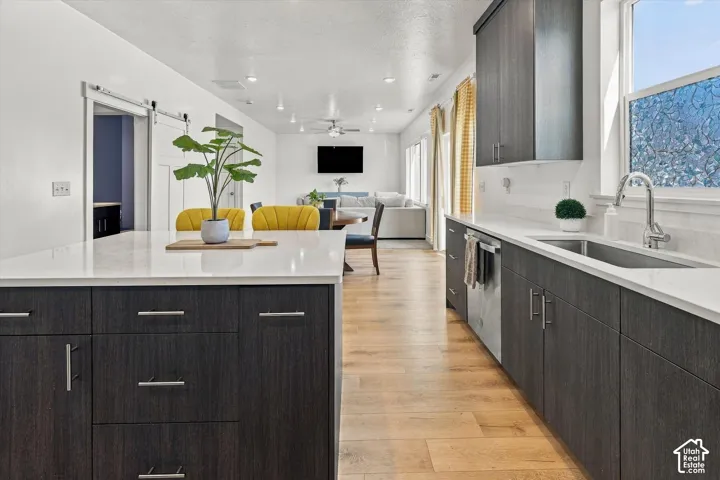 Kitchen island featuring a white countertop and dark wood-finish cabinetry