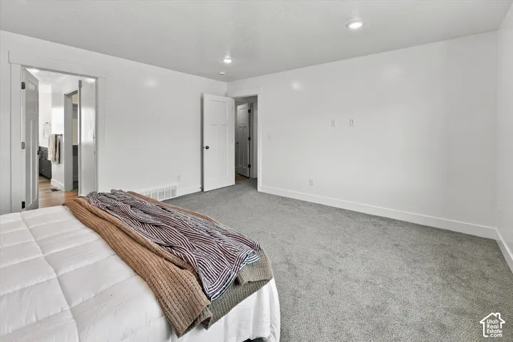 Recessed lighting, light gray carpeting, white walls, and white trim