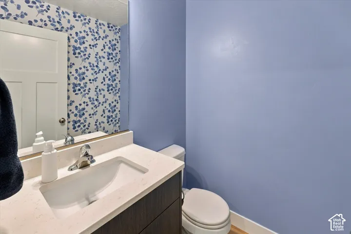 Integrated vanity with a rectangular sink, chrome faucet, and light-toned countertop
