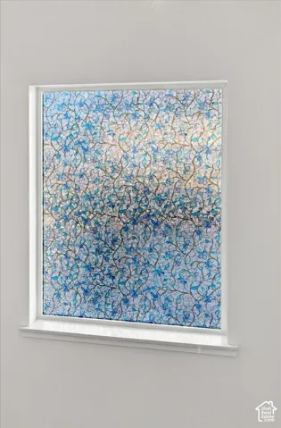Window with decorative patterned privacy film and a white sill