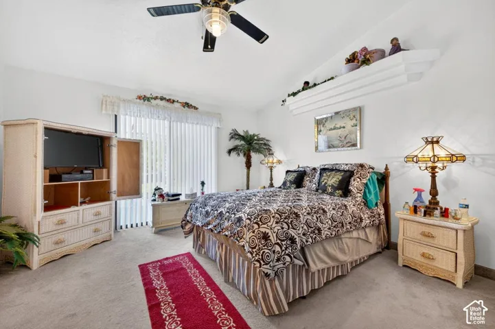 Recessed ceiling fan, textured white walls, wall-mounted display shelf, and light-colored carpeting