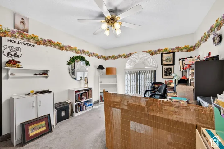Recessed ceiling fan with light fixture, arched window with horizontal blinds, and carpeting