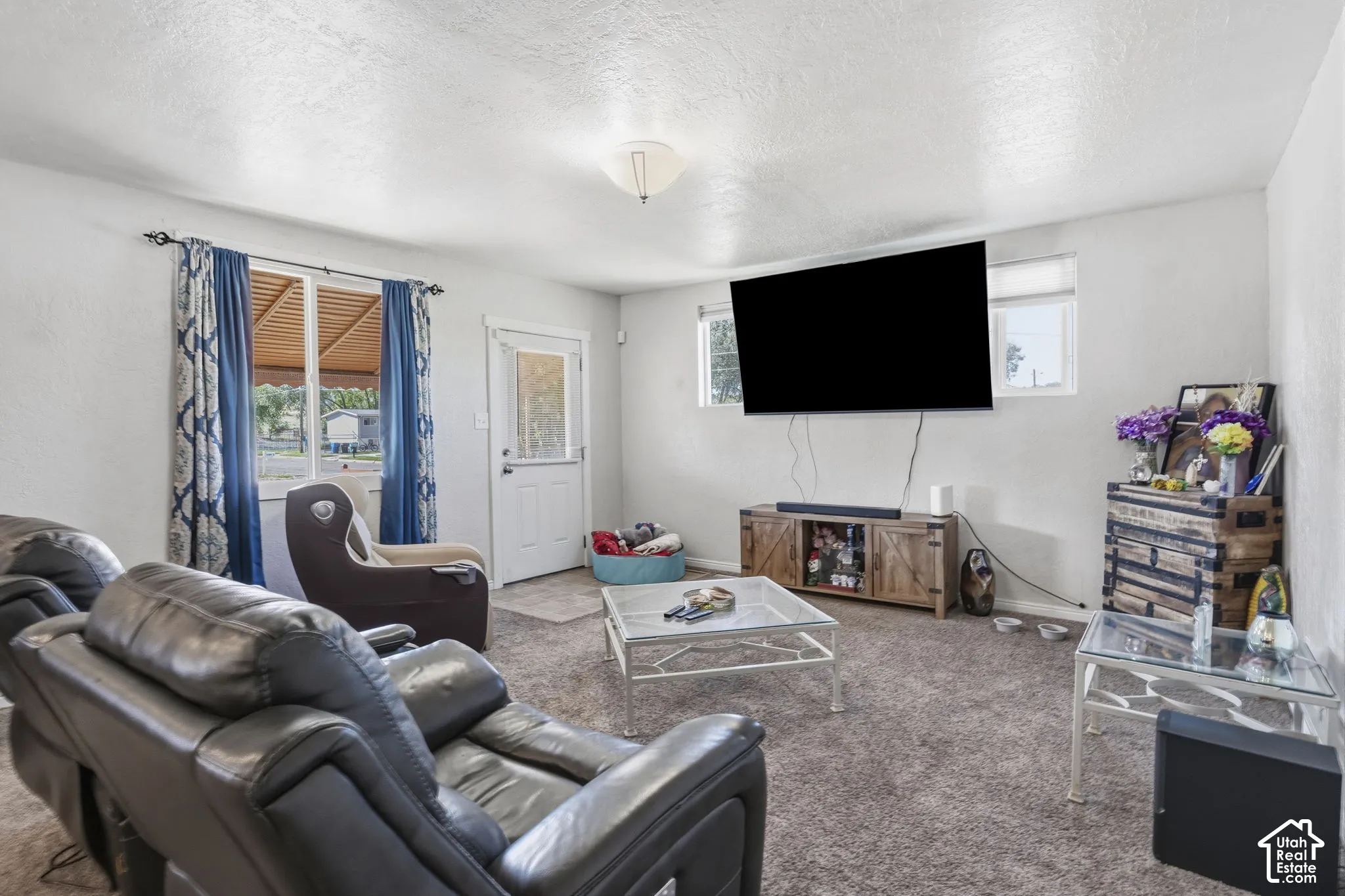 Carpeted flooring throughout, white walls, and a ceiling-mounted light fixture