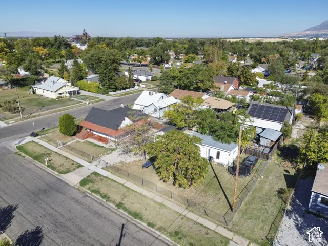 Fenced property with established trees and a paved street
