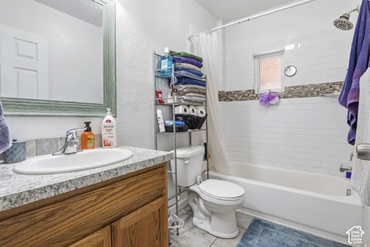 Bathroom featuring a white subway tile shower surround with a mosaic accent band