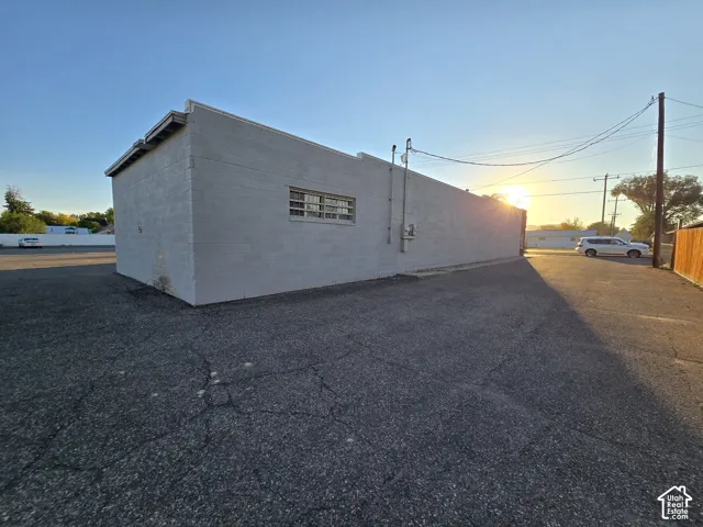 White block exterior with a single window featuring horizontal panes and a flat roofline