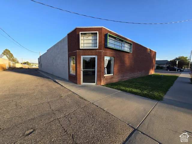 Brick exterior with a prominent corner entrance and multiple display windows