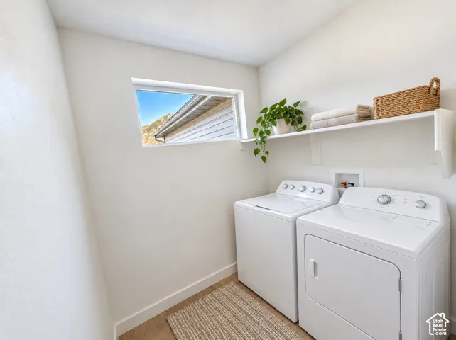 Integrated laundry area with a wide window, upper storage shelving, and durable flooring