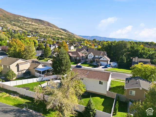 Manicured green spaces, mature trees, and a mountain backdrop