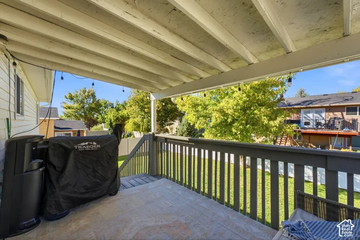 Covered patio with painted wood railings