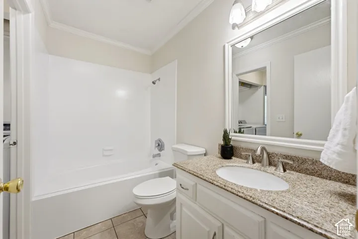 White vanity with a granite-style countertop, undermount sink, and brushed nickel faucet