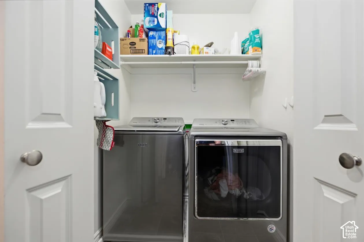 Integrated laundry area with shelving and a hanging rod