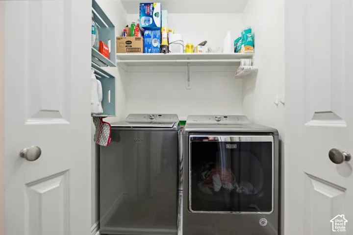 Integrated laundry area with shelving and a hanging rod