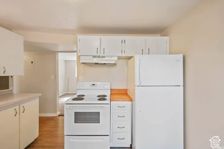 Kitchen featuring white cabinetry, white electric range, white refrigerator, and wood-finish countertops
