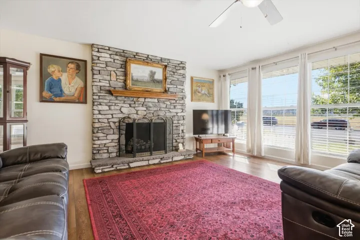 Living room with new hardwood floors, and updated fireplace.