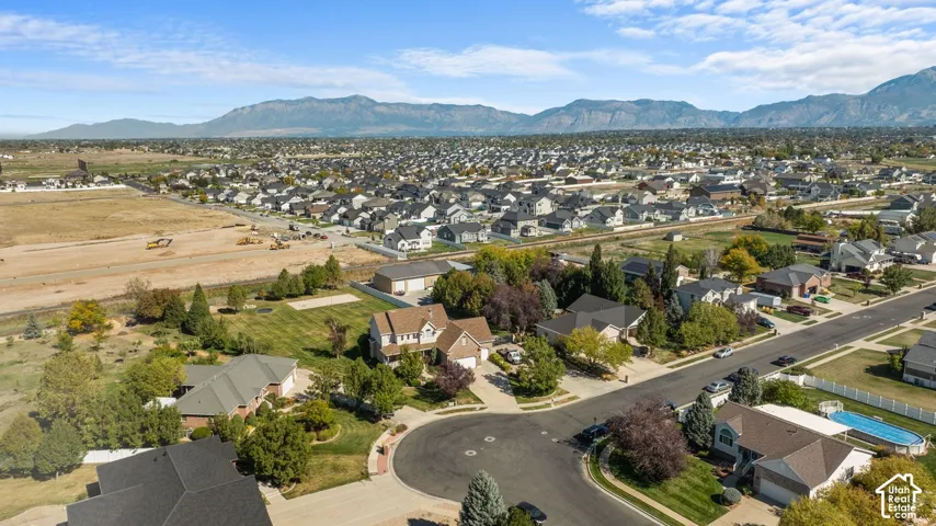Expansive suburban landscape with a cul-de-sac, mature trees, and mountainous terrain