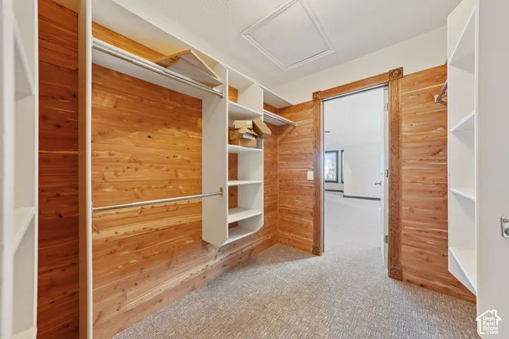 Custom closet system featuring cedar plank walls and integrated shelving