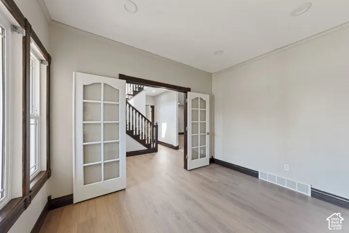 Light wood-finish flooring with dark trim