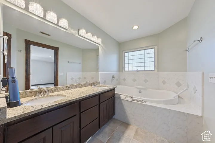 Dual sink vanity with granite countertop and dark wood-finish cabinetry