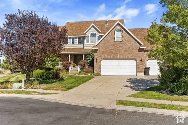 Brick and siding exterior with a multi-car garage