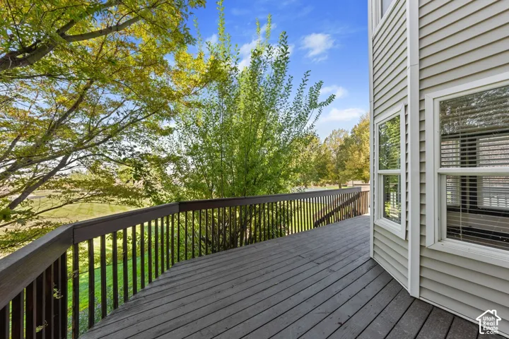Expansive outdoor deck with wood-finish flooring and railing