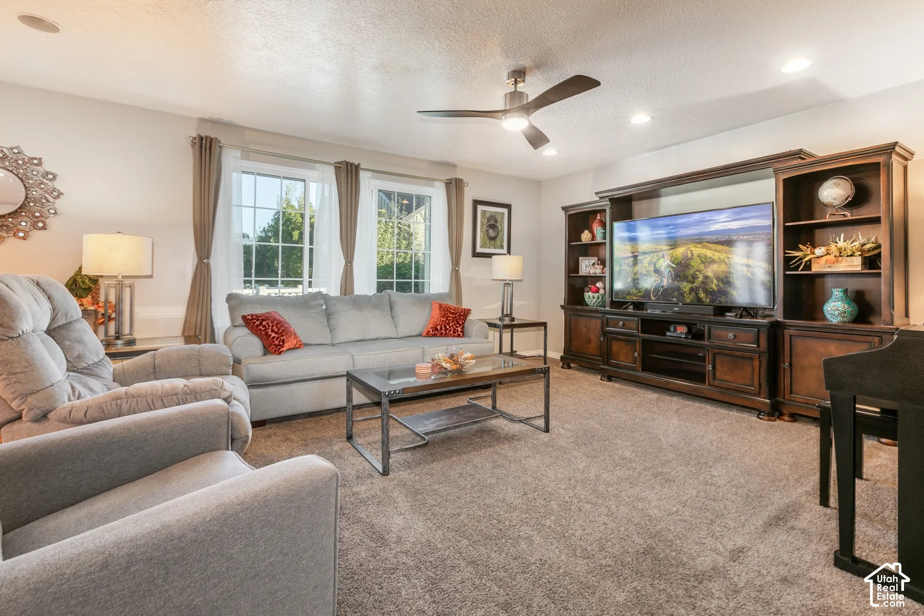 Recessed lighting, ceiling fan, carpet flooring, and a built-in media center with shelving