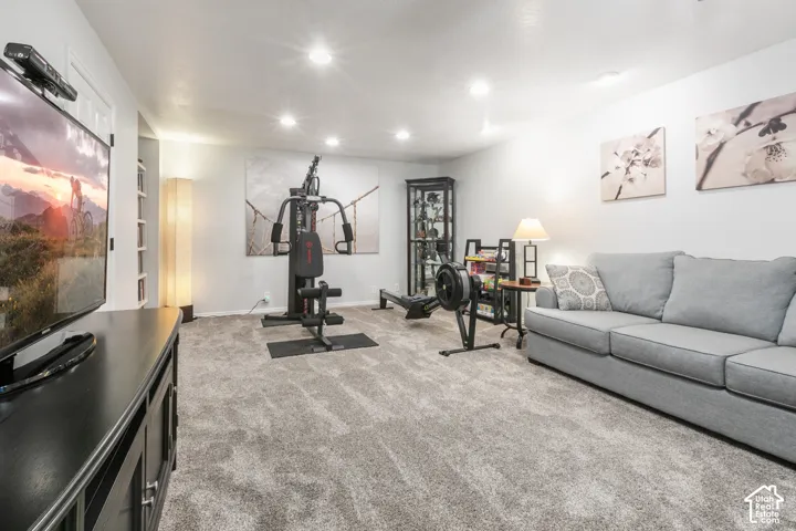 Recessed lighting illuminates the carpeted floor