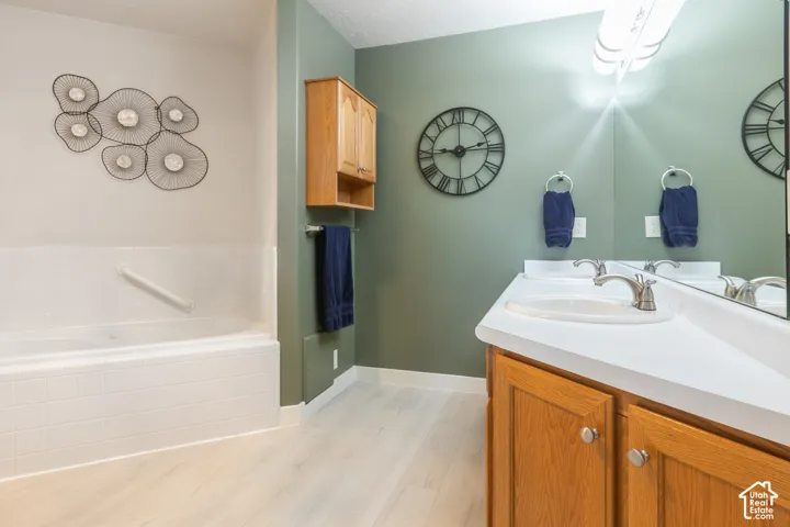 Dual vanity with integrated sinks, brushed nickel faucets, and wood cabinetry