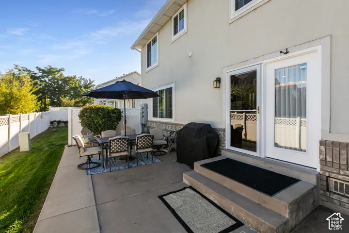 Concrete patio with direct outdoor access via a sliding glass door