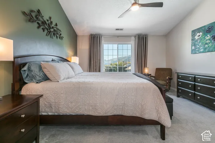Wall-to-wall carpeting, recessed window with grid panes, textured ceiling, and ceiling fan
