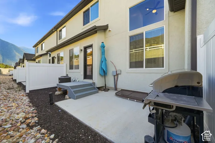 Private concrete patio with steps leading to an exterior door